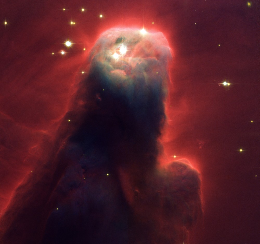 Красное излучение вокруг скопления пыли и газа в созвездии Единорога, снимок сделан с телескопа Hubble в 2002 году.